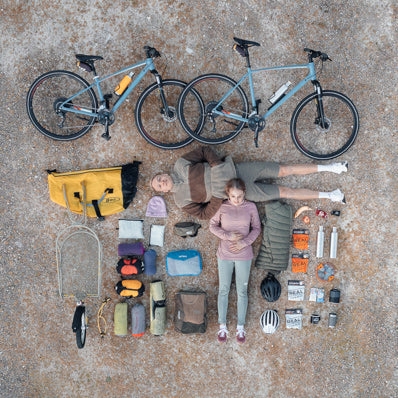 Couple with Croozer BOB bike trailer and camping gear - complete bike touring and adventure cycling setup