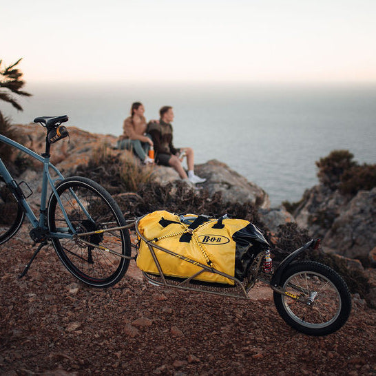 Couple taking a break from their bike tour - BOB cargo trailer with BOB bag and resting aside