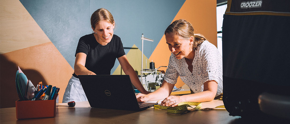 Happy Croozer team members working on new products in the office