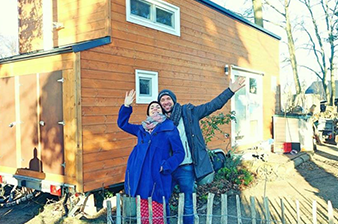 Croozer cooperation with Max - two people waving to camera in front of house
