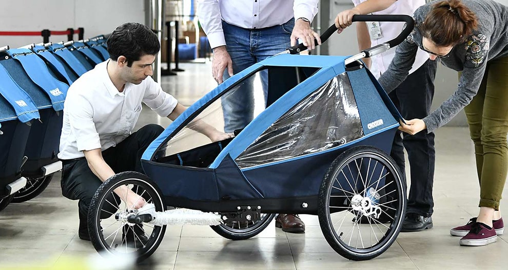 Croozer bike trailer quality control and assembly - Manufacturing team inspecting bike trailers