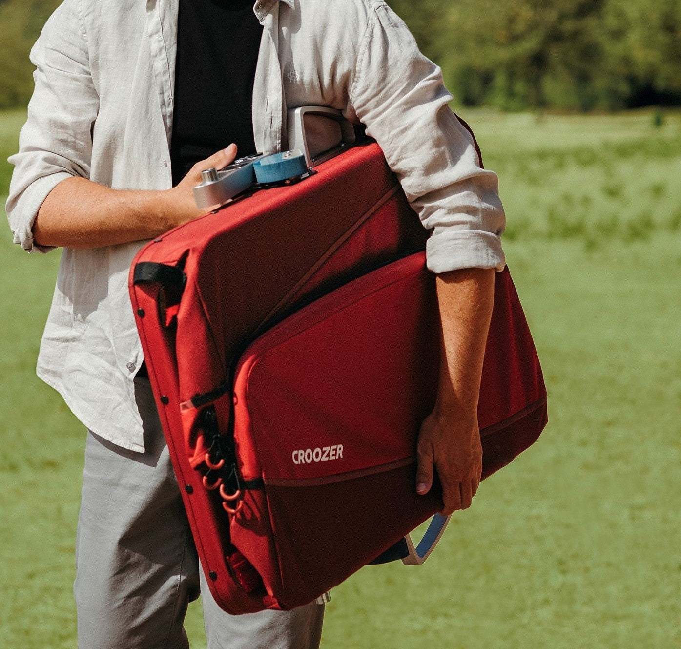 Croozer Cargo Tuure easily folded and carried by young man