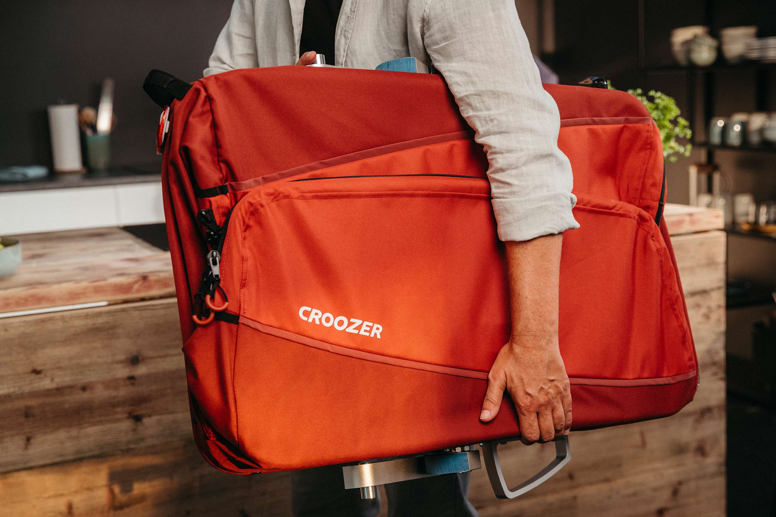 Croozer Cargo Tuure easily folded and carried by young man