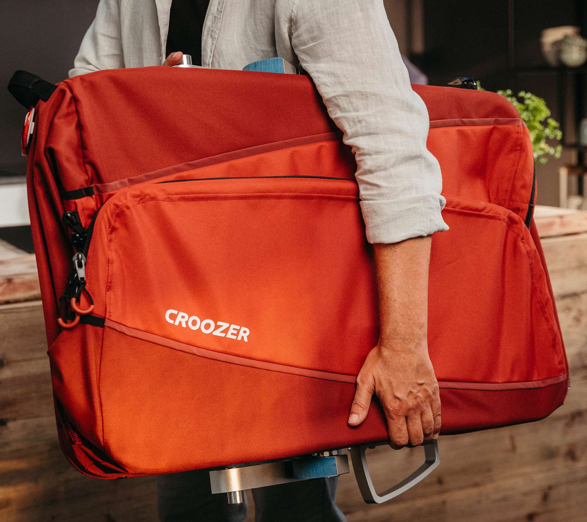 Croozer Cargo Tuure easily folded and carried by young man