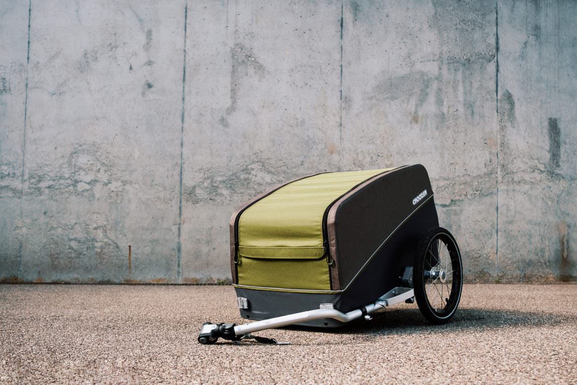 Croozer Tuure cargo trailer with aluminum hitch arm on gravel surface